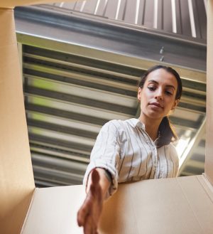 Woman Reaching into Box